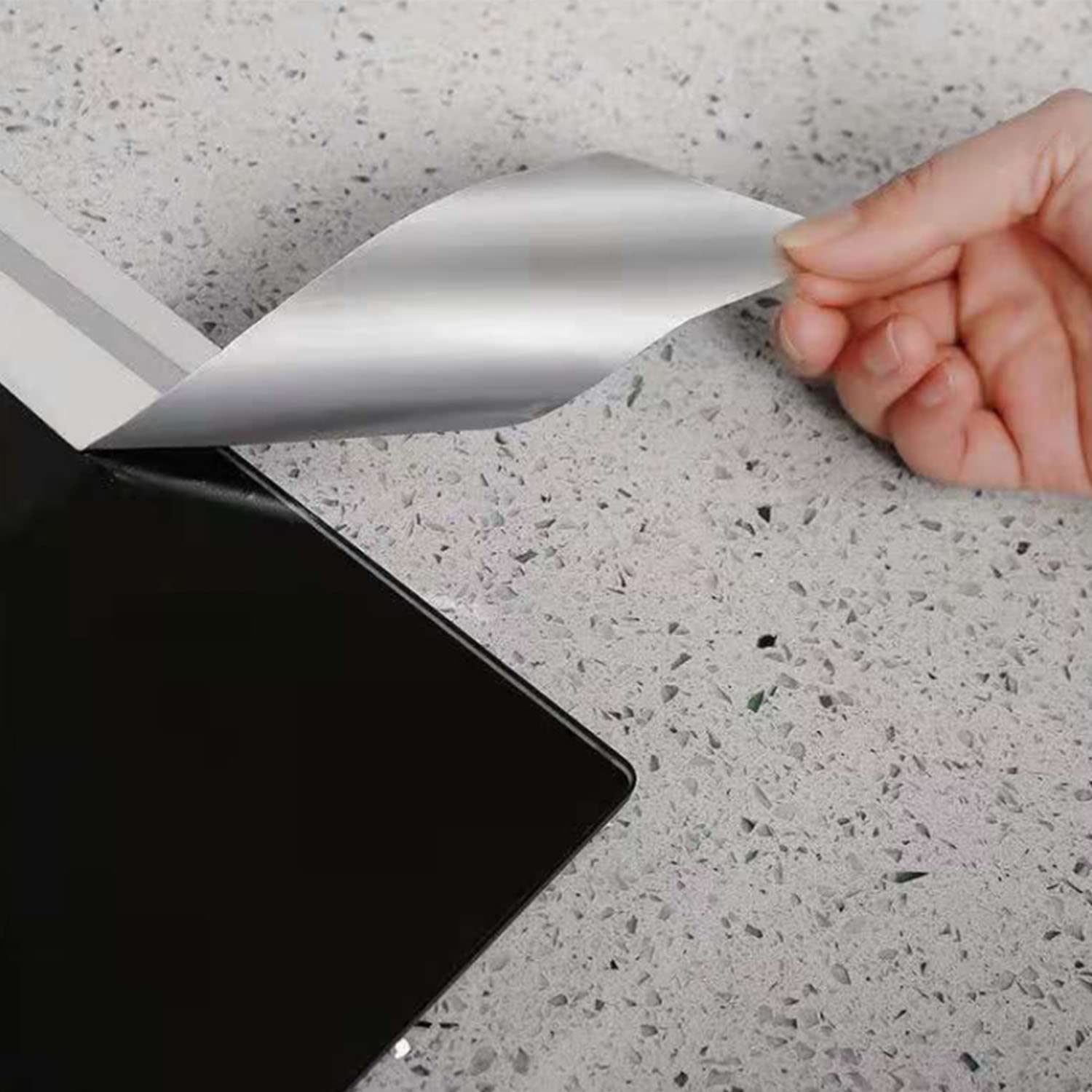 A person sticking a Leakproof Aluminum Foil Tape on a counter top