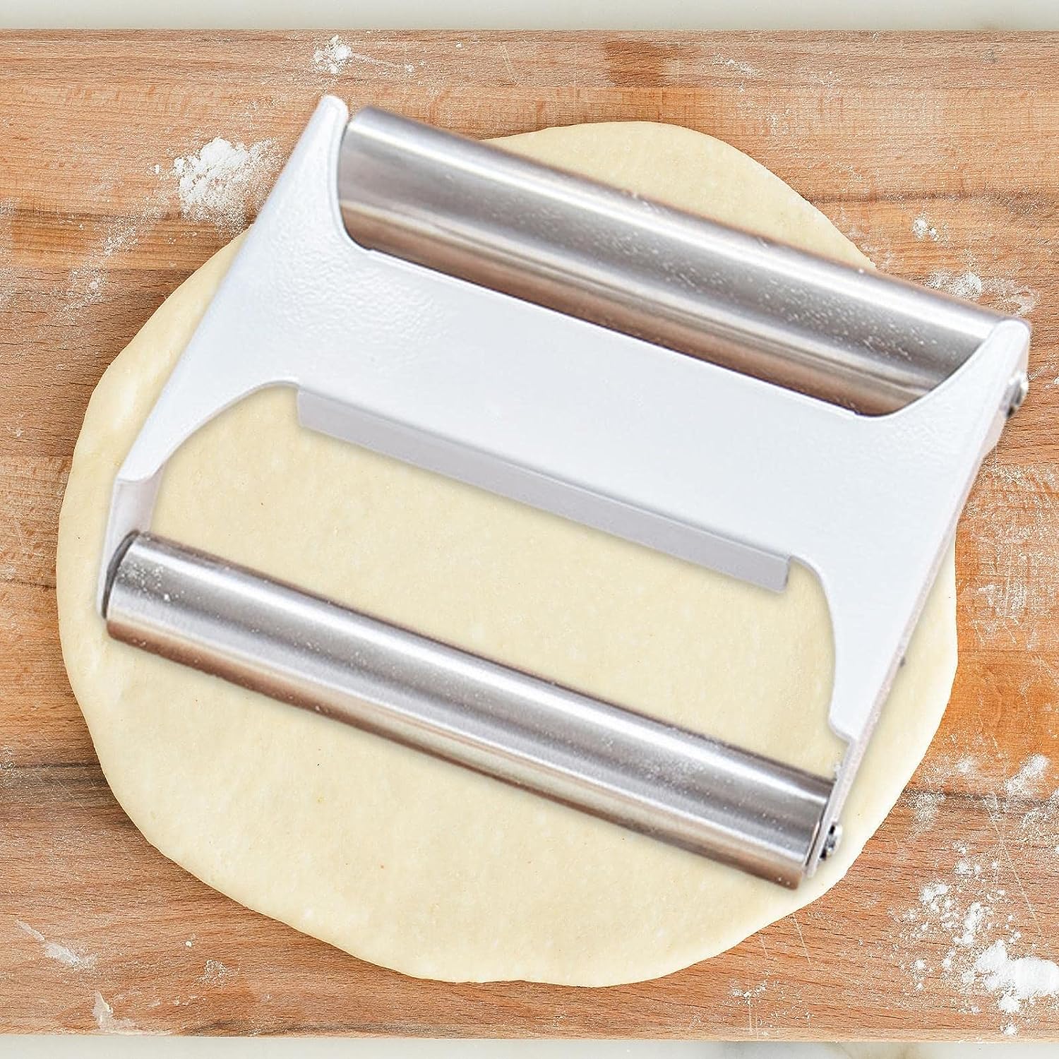 Double-Sided Stainless Steel Dough Roller with Dumplings on it