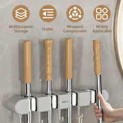  A person Hanging mop in Wall-Mounted Mop Holder & Broom Hanger