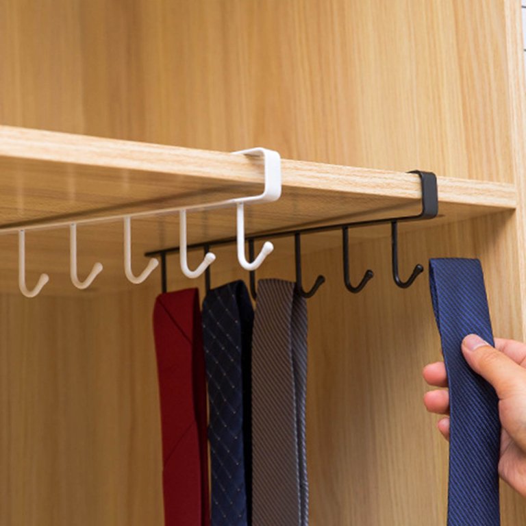 A tie being hung on a metal hanger with 6 hooks for multifunctional organization.