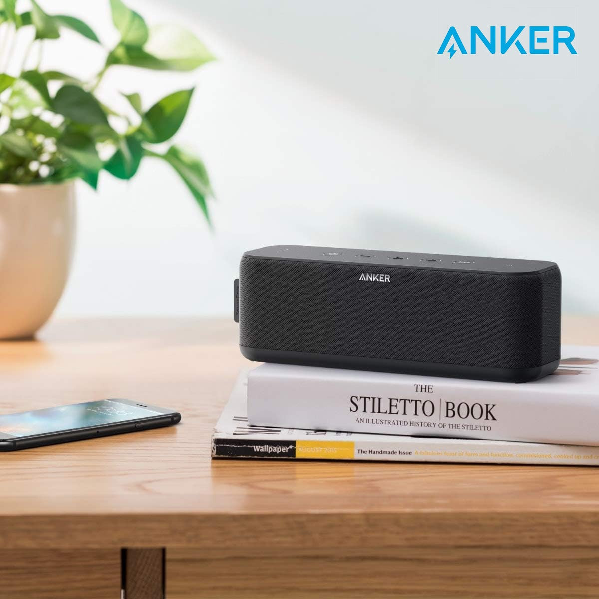 ANKER Soundcore Boost Portable Waterproof Bluetooth Speaker Placed Above Books on the Table.