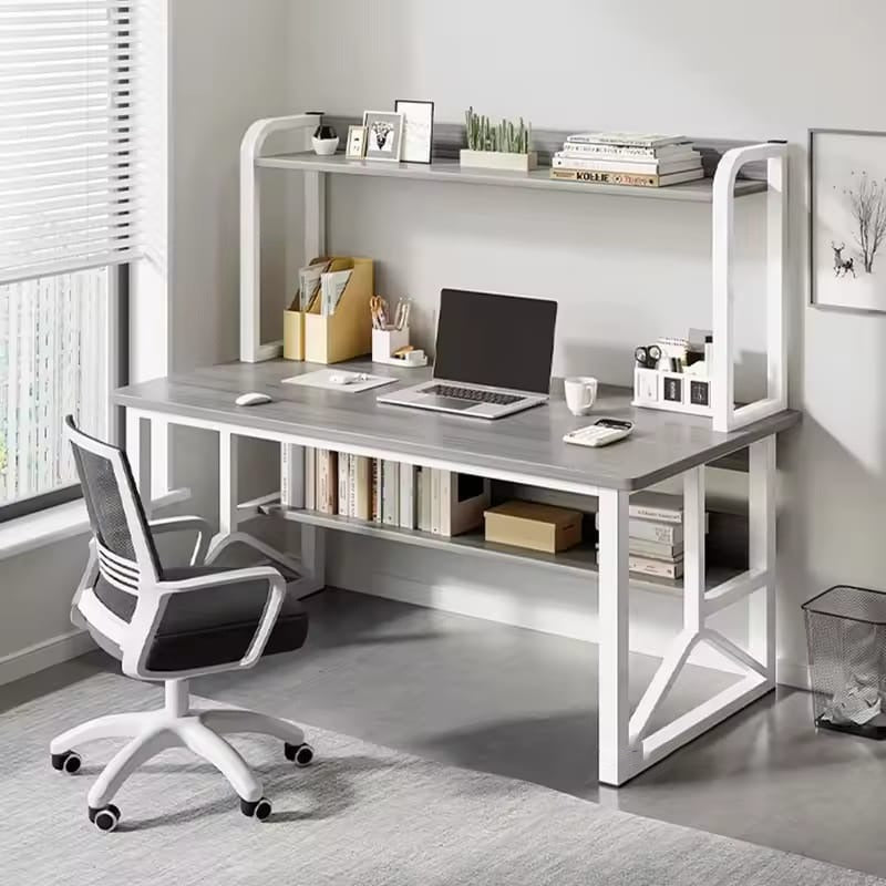 A Computer Desk is Organized with Laptop Books and Decor Items.