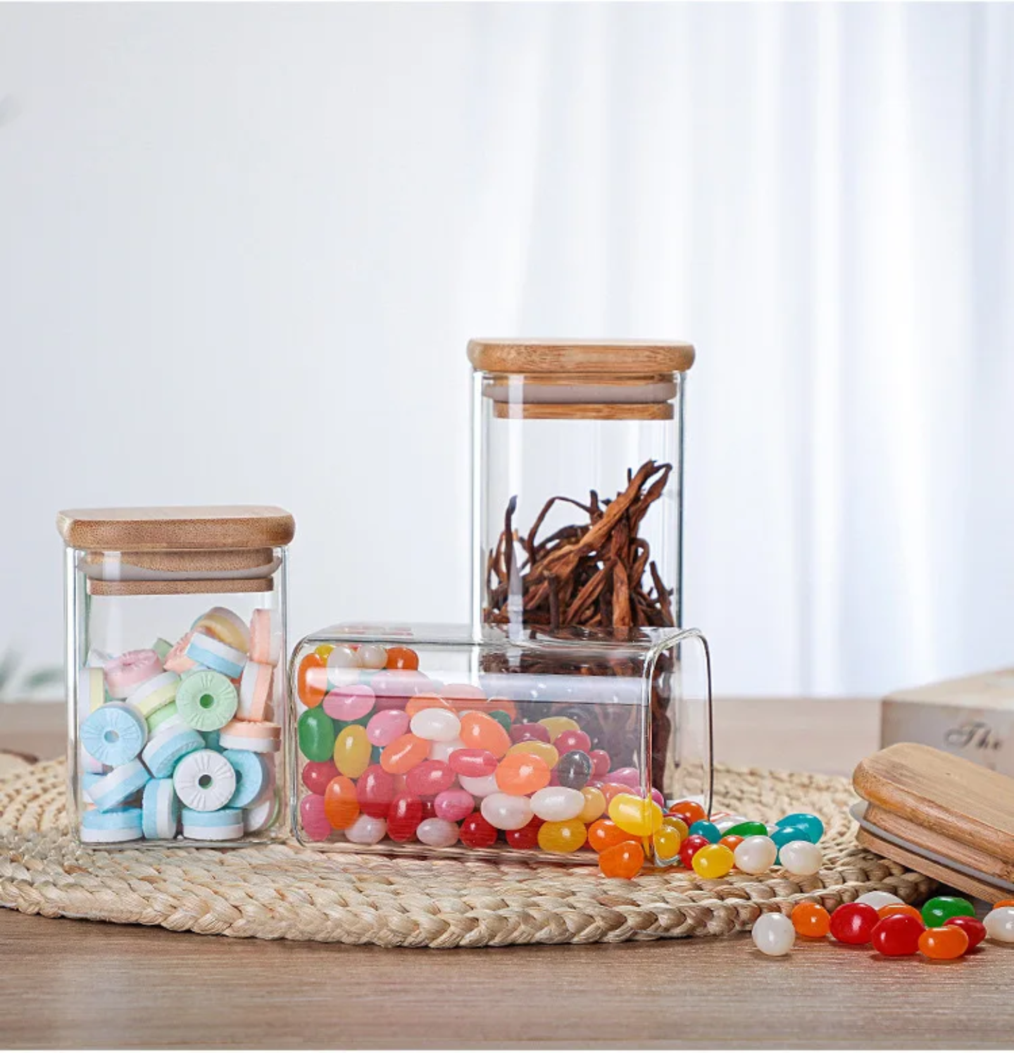 A Set Of Glass Storage Jars  are Filled with Candies.