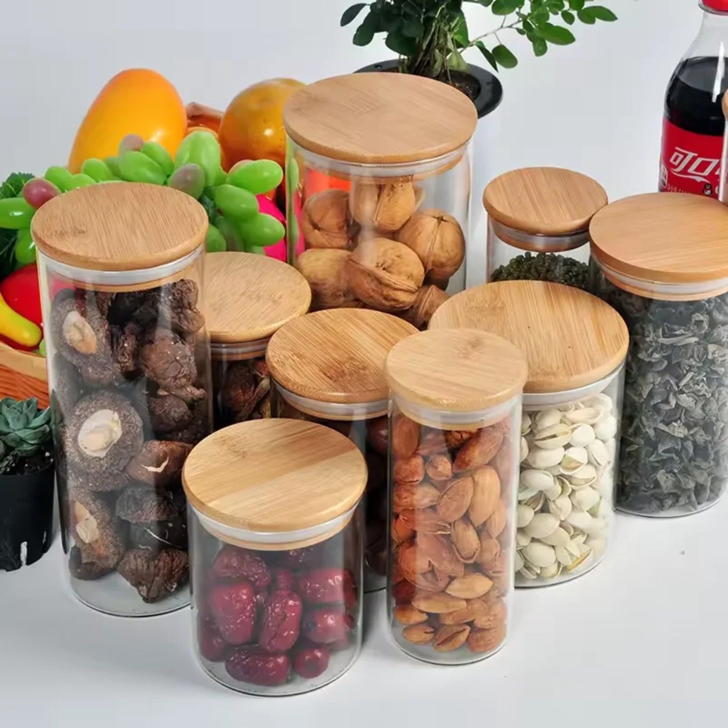 A Set Of Glass Storage Jars  are Filled with Dry Fruits.