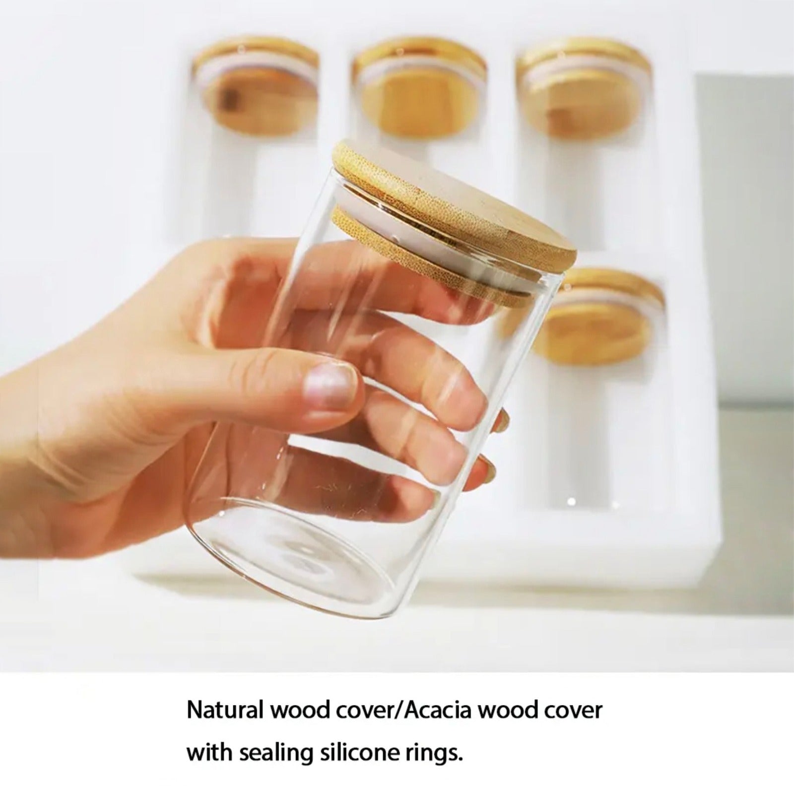 A Person is Holding Glass Storage Jars.