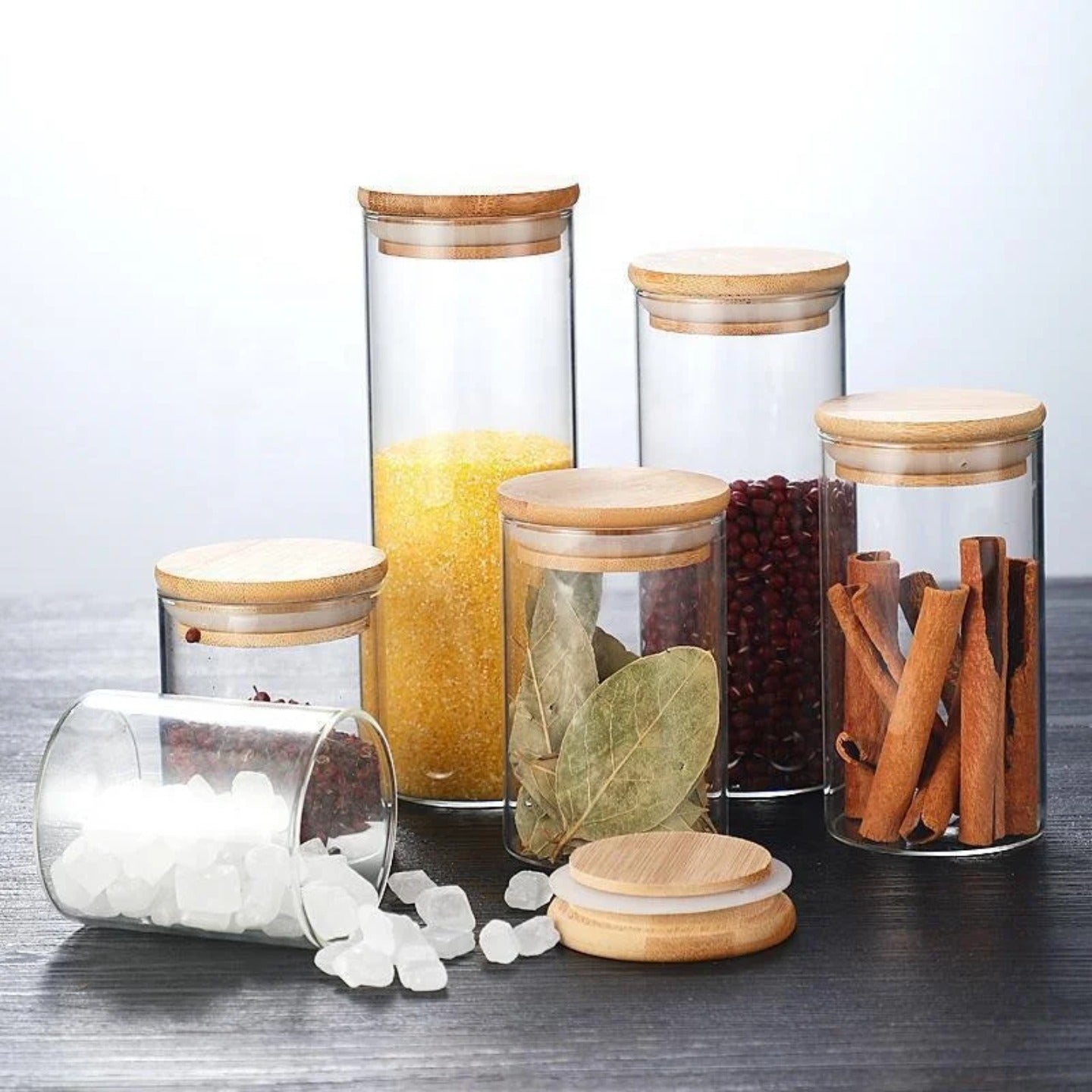 A Set Of Glass Storage Jars  are Filled with Spices.