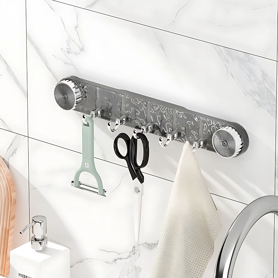 A Wall Mounted Suction Hook Holder is Fixed on a Wall Holding Kitchen Essentials.