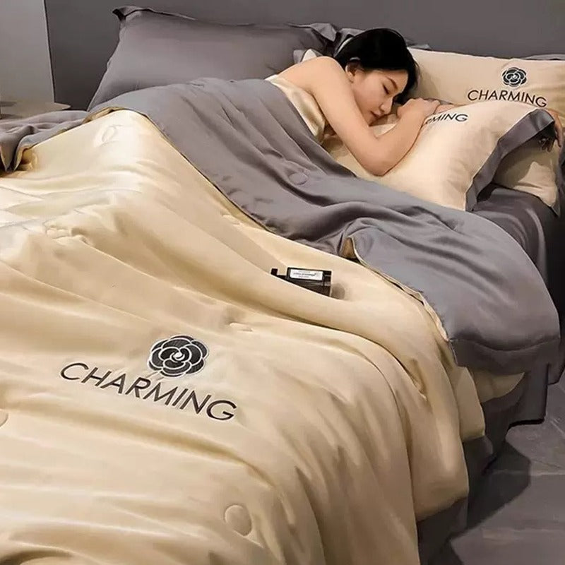 A Woman is Sleeping on Summer Quilted Cooling Comforter Bedding Set.