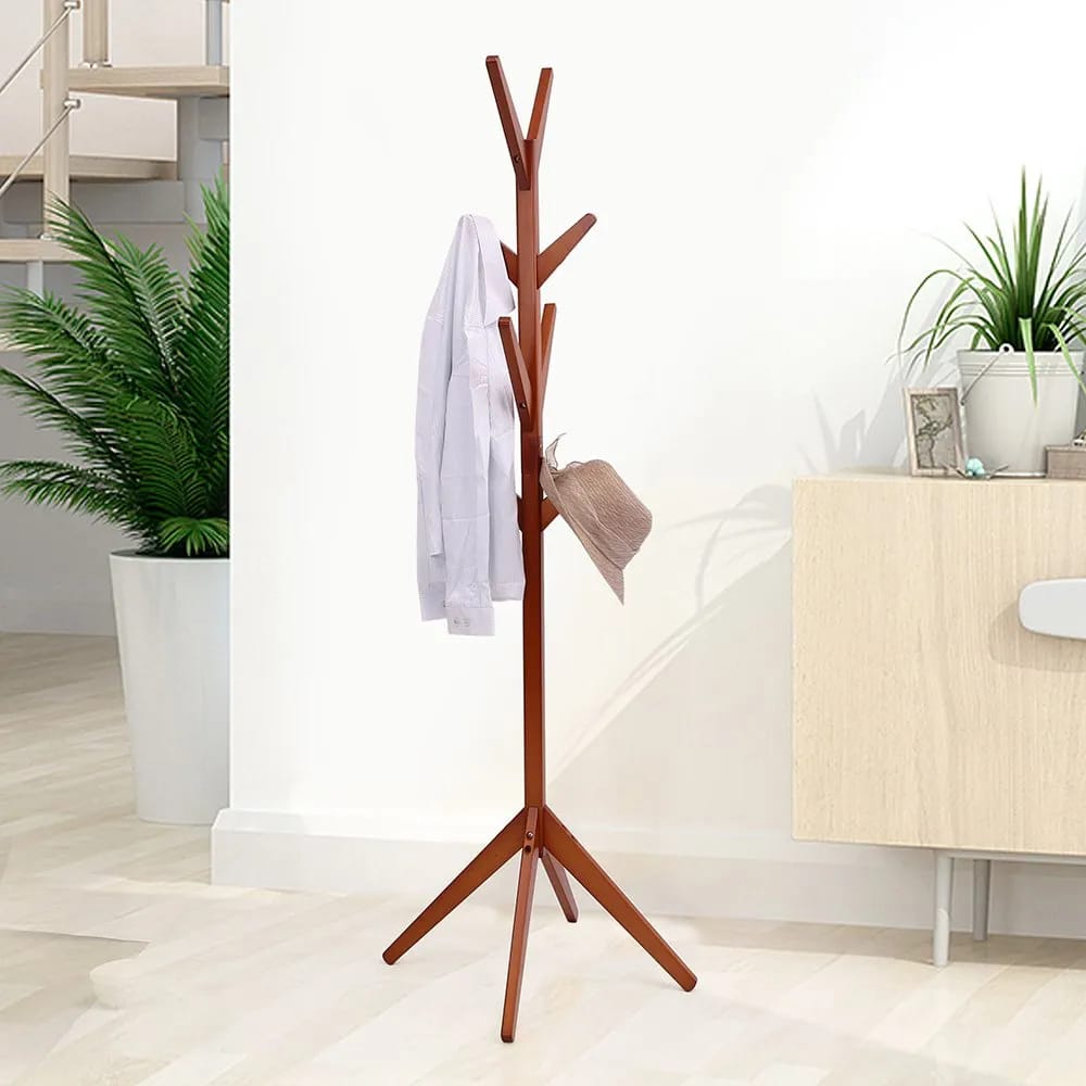 A Wooden Cloth Hanger Stand with Cloth and Hat On it.