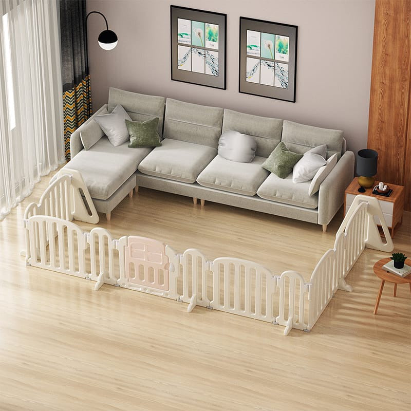 A baby playpen set up in a living room.