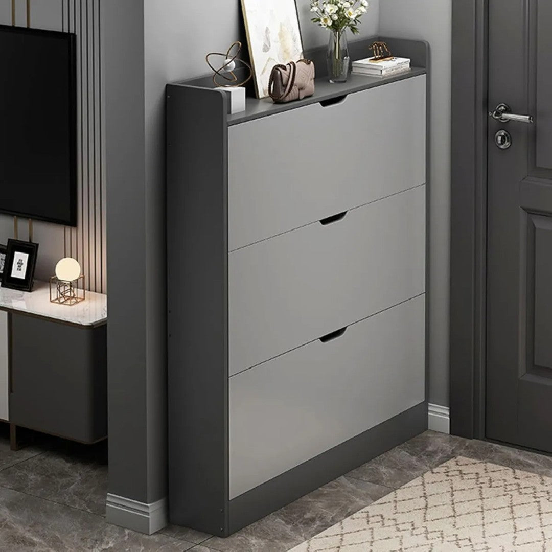 A modern shoe cabinet shelf with flip drawers placed in a stylish entryway.