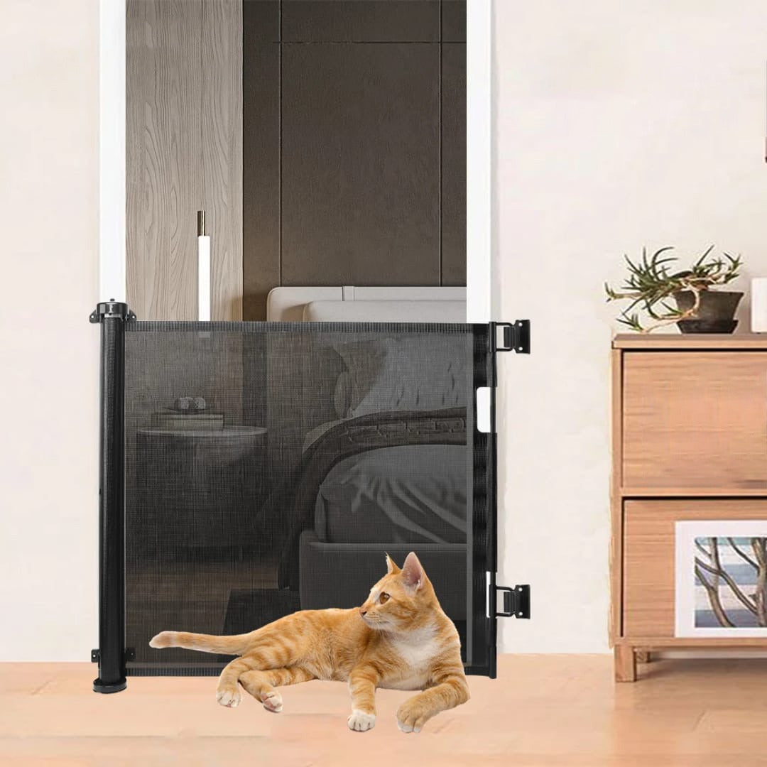 A retractable baby and pet safety gate positioned in front of a bedroom