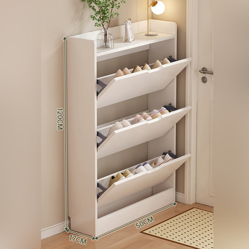 A slim shoe cabinet with flip drawers that neatly stores shoes while saving space, with a top surface for décor or essentials.