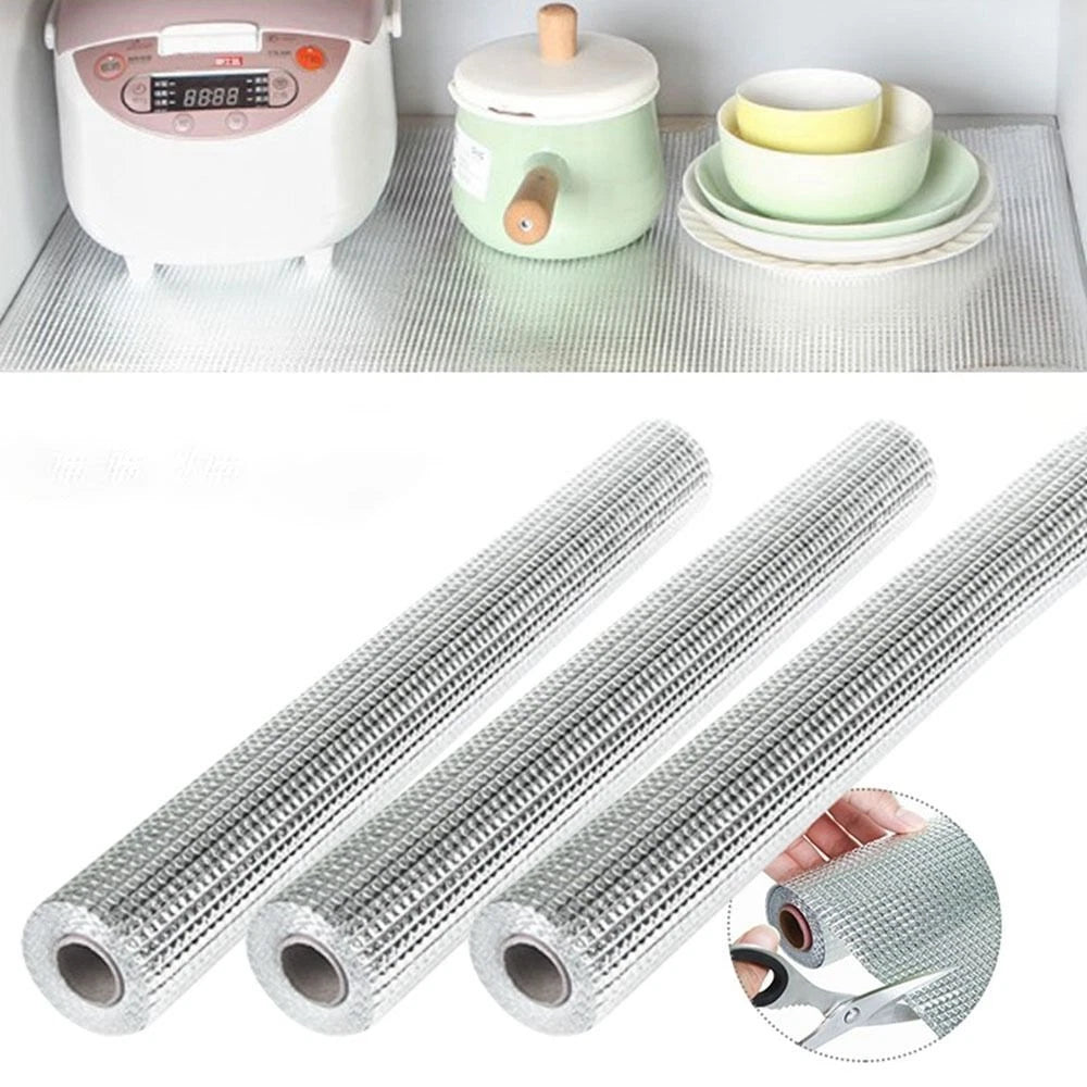 A textured anti-slip shelf liner roll shown in multiple pieces, used under kitchen appliances and dishes to prevent slipping, protect surfaces, and keep cabinets clean and organized.
