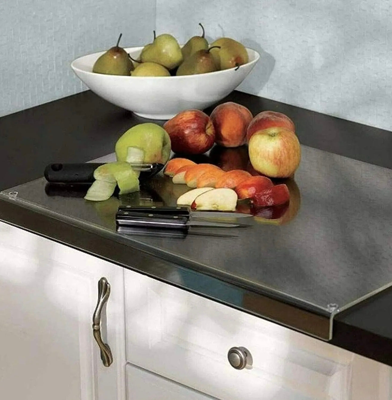 Fruits and Knives are Placed on an Acrylic Cutting Board.