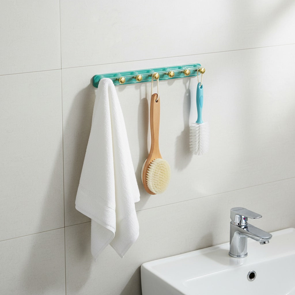 Adhesive Wall Hooks with hooks holding a towel, brush, and scrubber against a tiled bathroom wall.