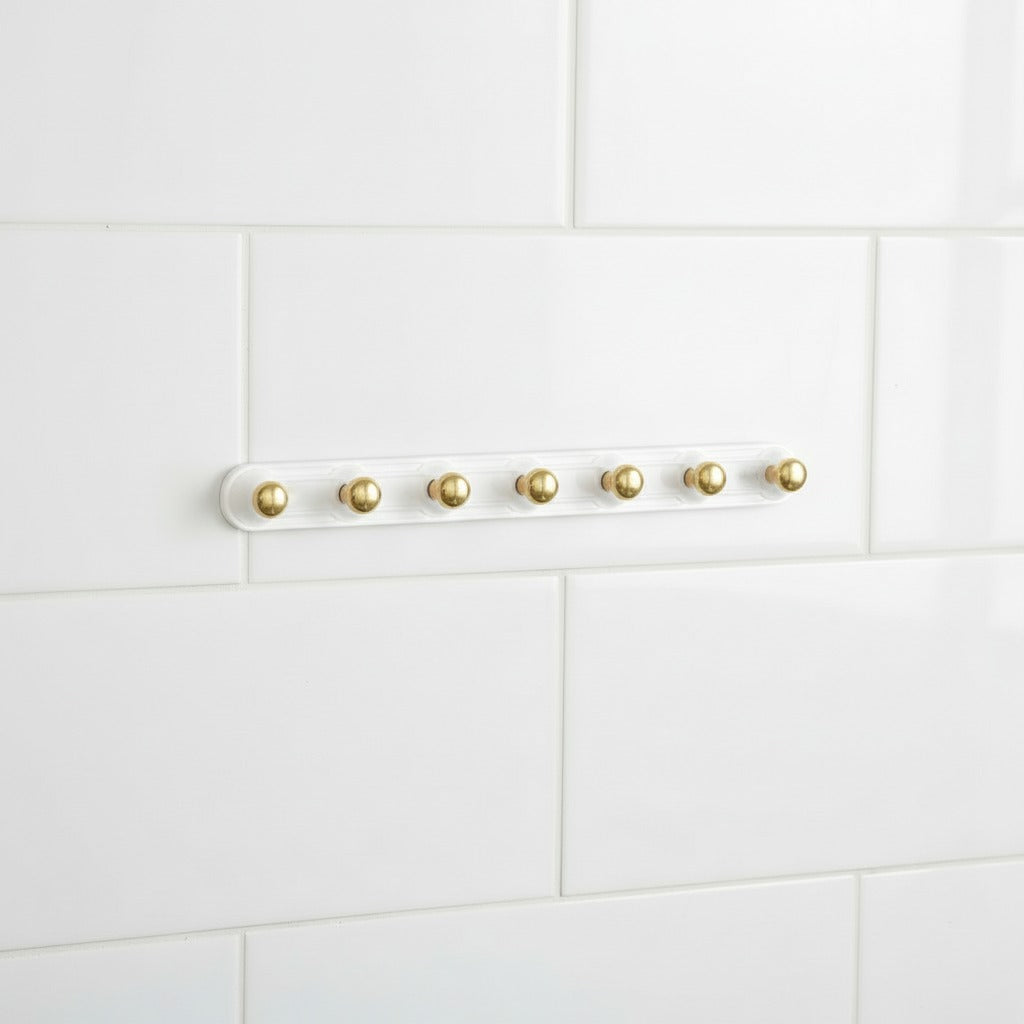 Adhesive Wall Hooks on a white tiled wall background