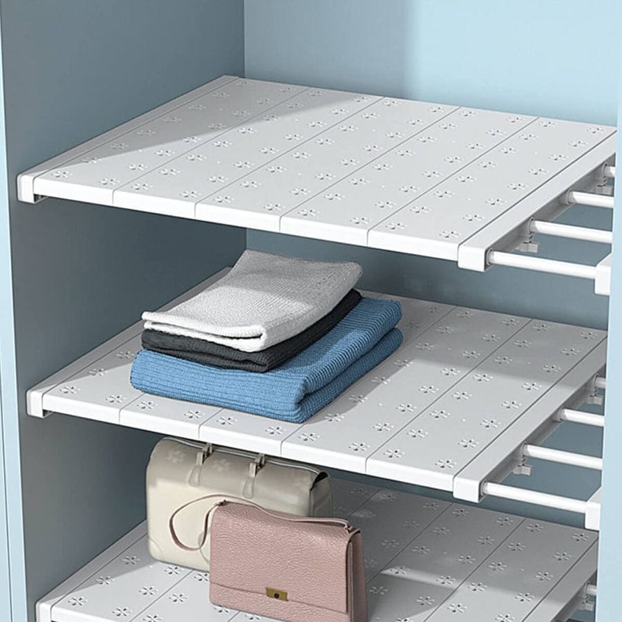 Expandable Closet Tension Shelf Divider with something arranged on it