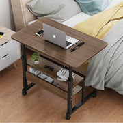 Adjustable Laptop Computer Desk with Bottom Shelf Placed Near Bed.