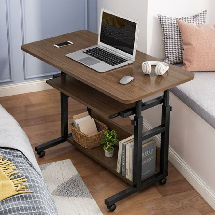 Adjustable Mobile Computer Desk with laptop, phone, and headphones in a bedroom setting.