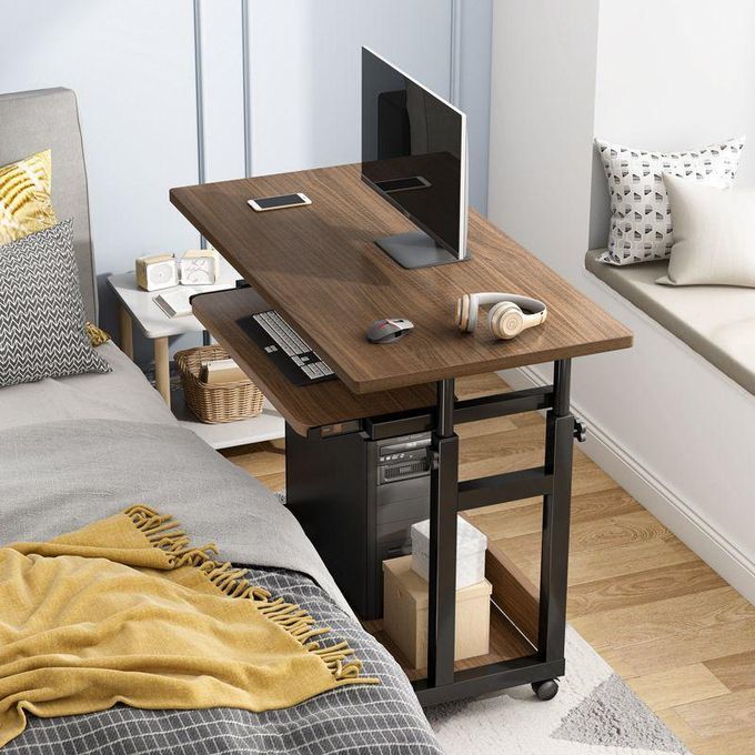 Adjustable Mobile Computer Desk in a bedroom with a computer setup