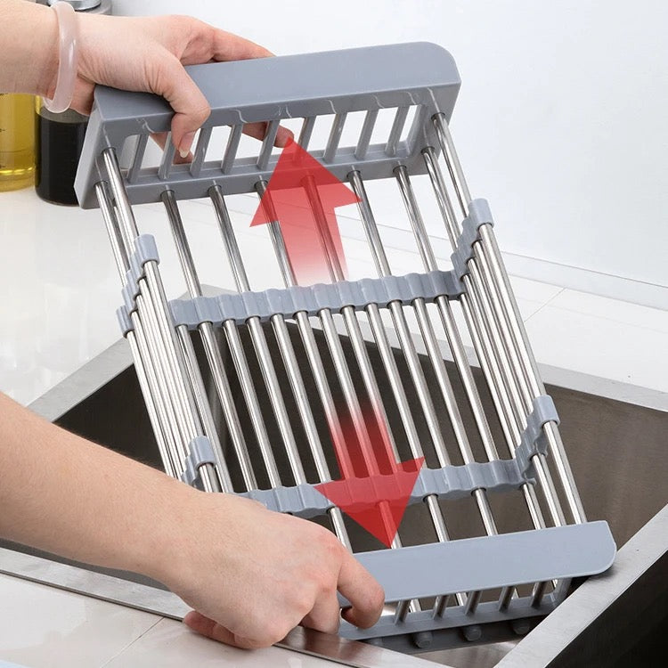 Someone placing an expandable dish drying and washing basket