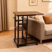 Adjustable Overbed Laptop Table in a living room setting with a sofa and cushions.
