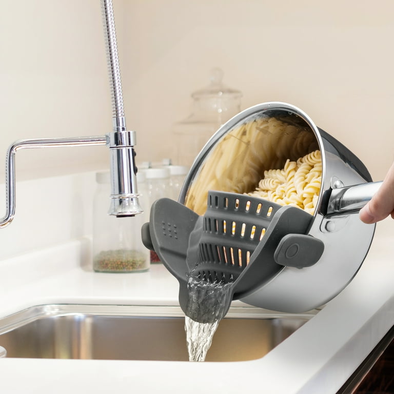 A Person is Straining Pasta By Attaching Adjustable Silicone Pot Pan Bowl Strainer.