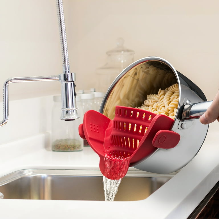 A Person is Straining Pasta By Attaching an Adjustable Silicone Pot Pan Bowl Strainer.