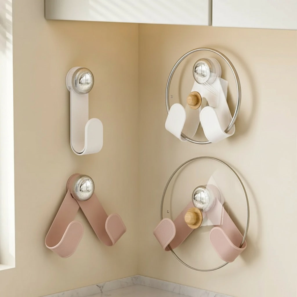 Wall hooks with glass lids on a beige wall