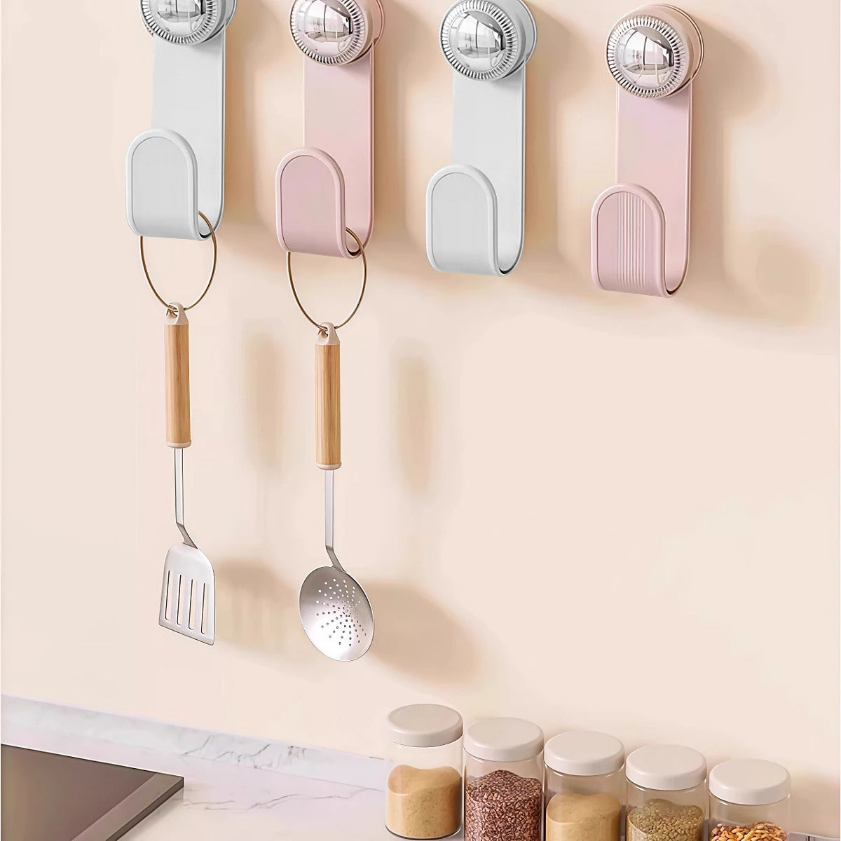 Set of Adjustable Wall Hook Attached on the wall holding cookware.