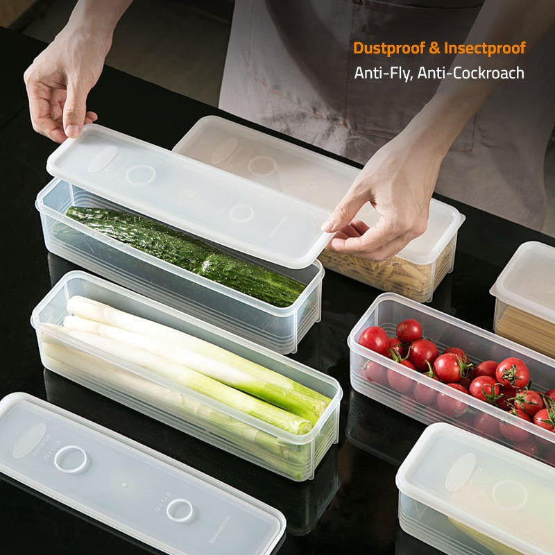 A Person is Storing Vegetables in  Airtight Rectangular Storage Box.