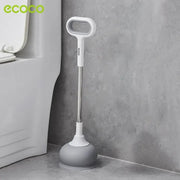 An Ecoco toilet plunger is placed on the bathroom floor beside a toilet.