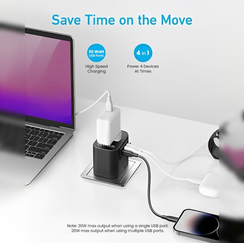Anker 312 Outlet Extender Travel Adapter placed on the table next to a laptop and mobile both plugged into it