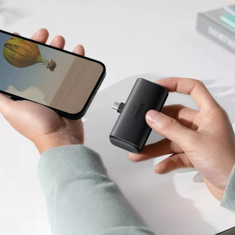A Person is Connecting Anker Nano Power Bank 5,000mAh to his Mobile Phone.