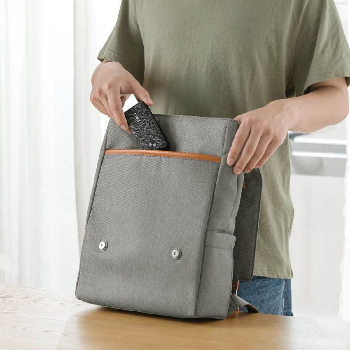 A man packing the Anker PowerCore Metro 10000mAh Fast Charging Power Bank into his bag
