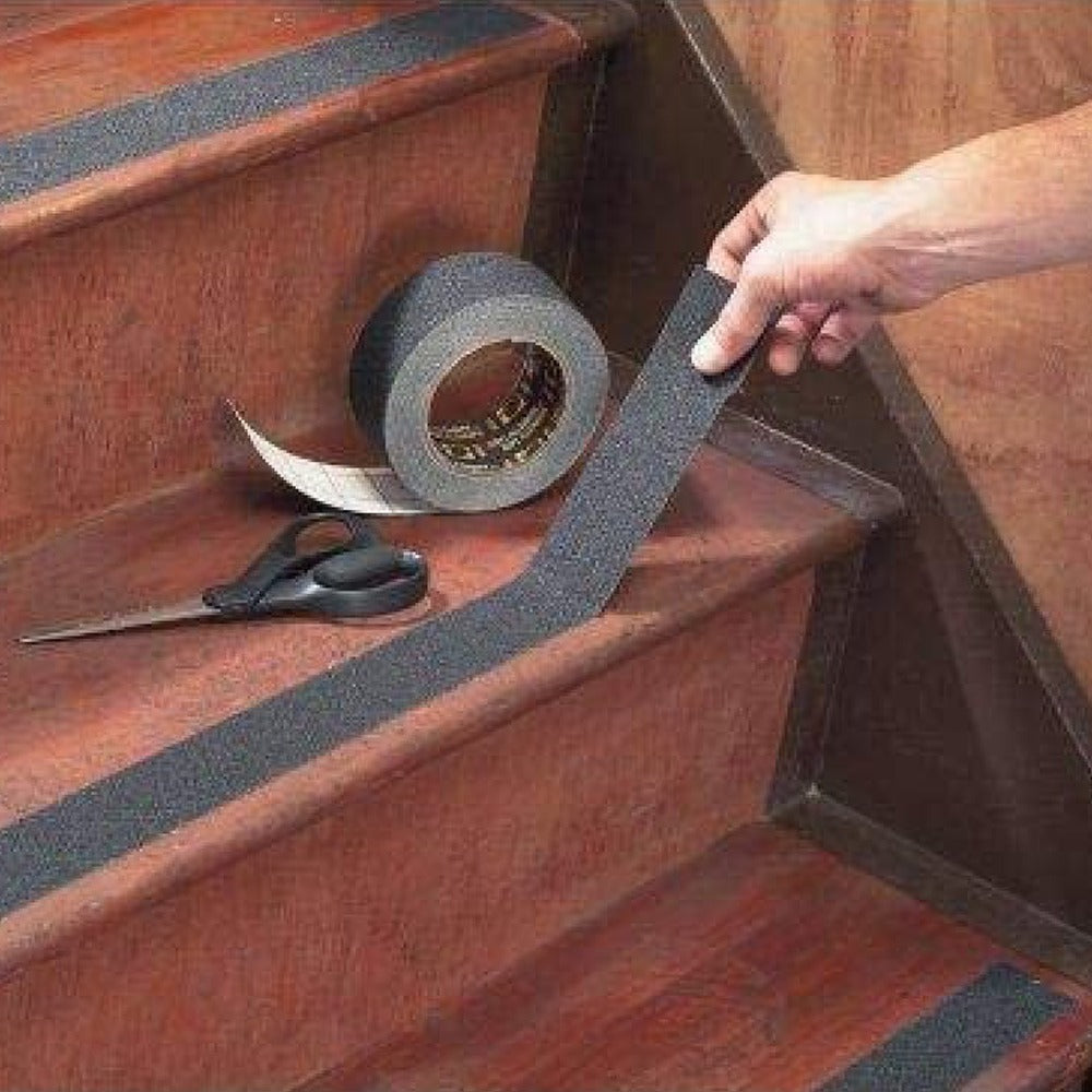 A Person is Fixing Anti- Slip Tape On Staircase.