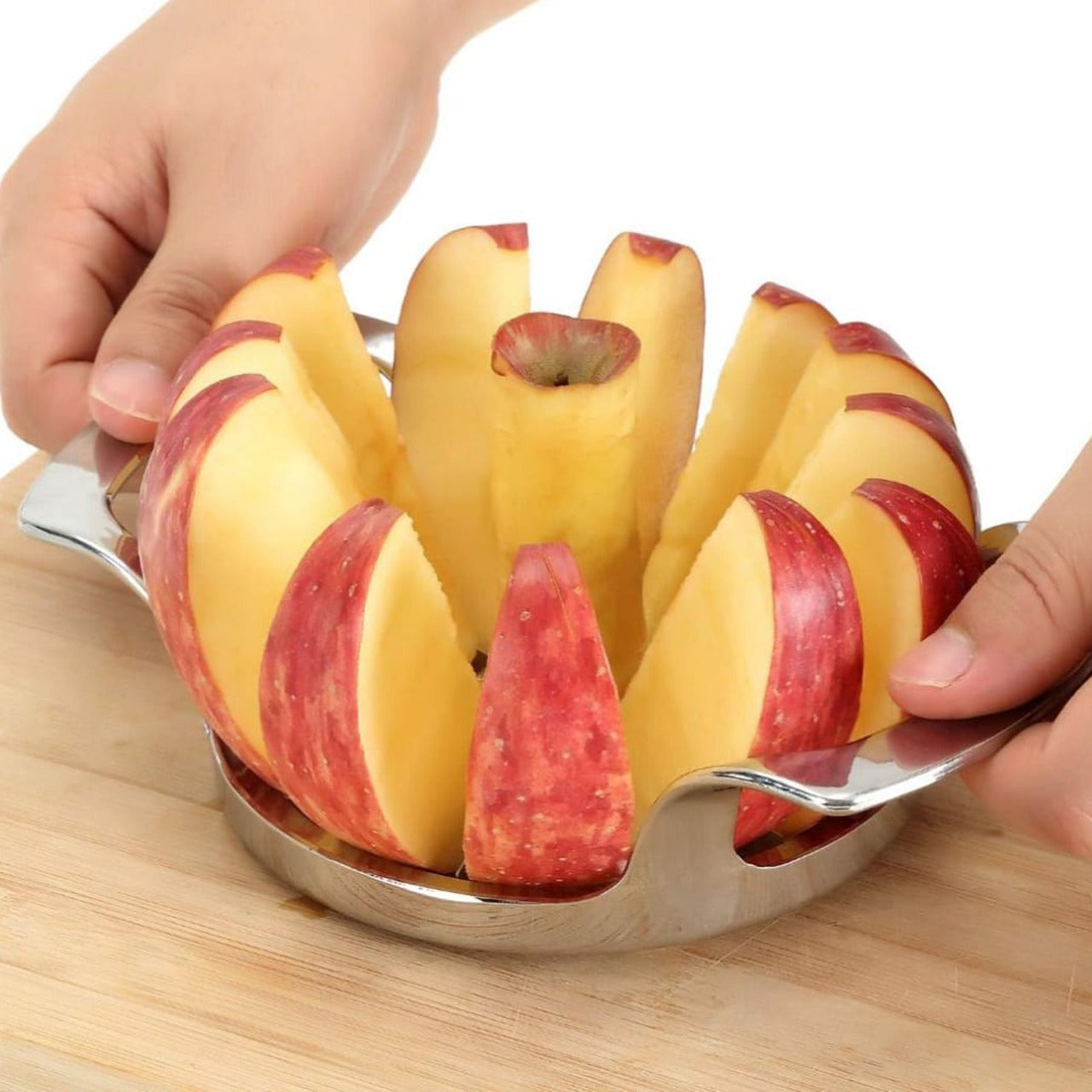 A Person is Cutting Apple Using Apple Cutter Slicer Corer.