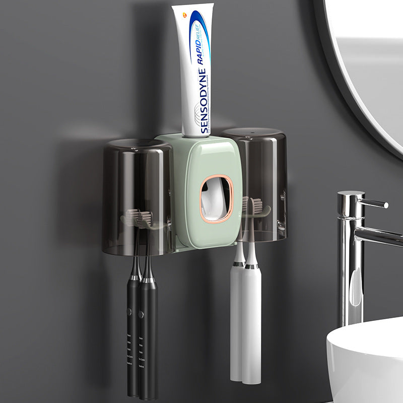 Automatic Toothpaste Dispenser With Brushes and Toothpaste Are Placed On it.