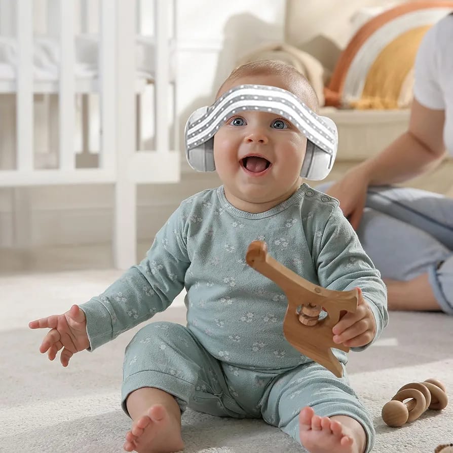 A Baby is Wearing Baby Ear Muffs.