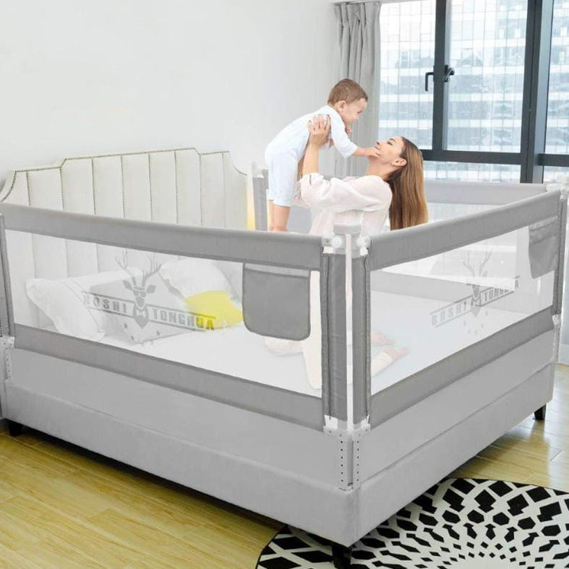 A Baby and Mother is Playing Inside a Bed Protected with Baby Bed Rail.
