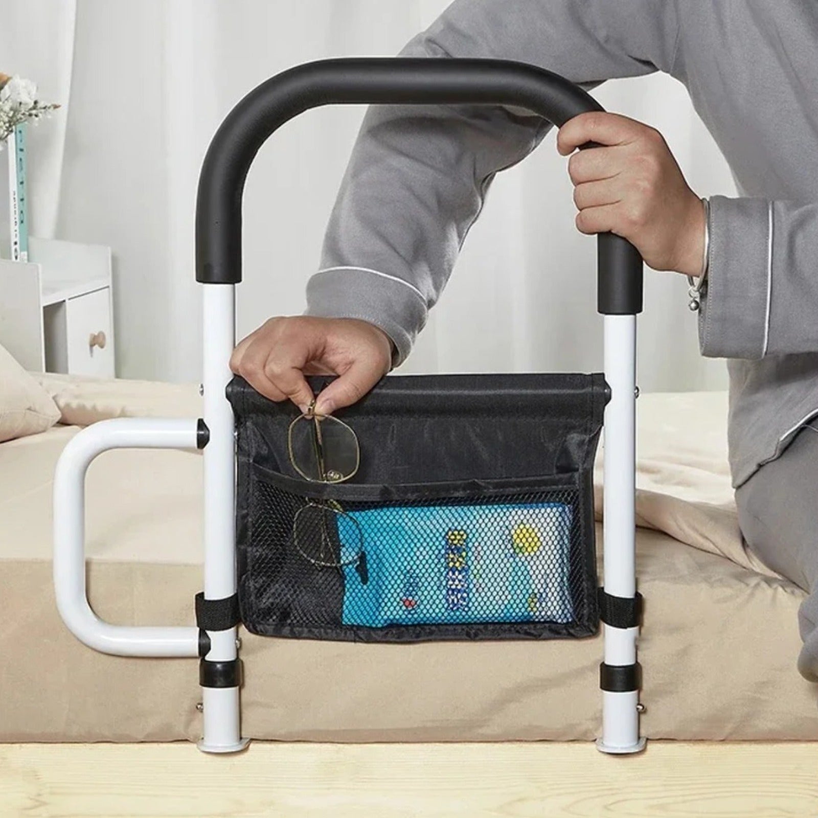 A Person is Keeping his Specs on the Storage Pocket of Bed Assist Rail with Safety Handle.