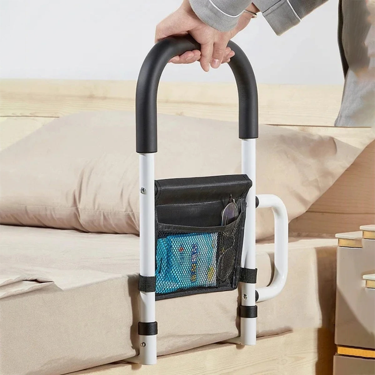A Person is Standing with the aid of Bed Assist Rail with Safety Handle.