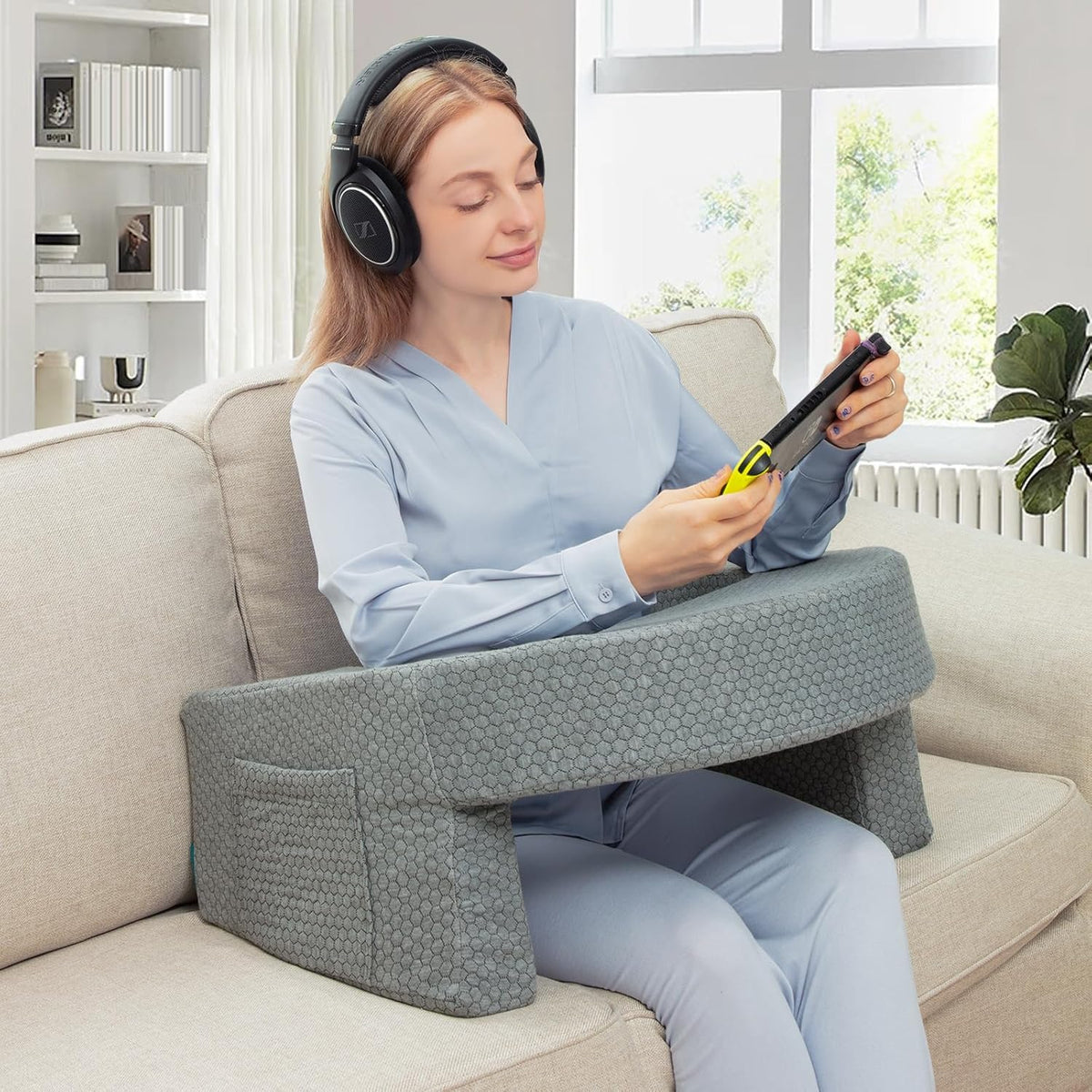 A Woman is Using Phone with the Support Of Bed Reading Pillow.