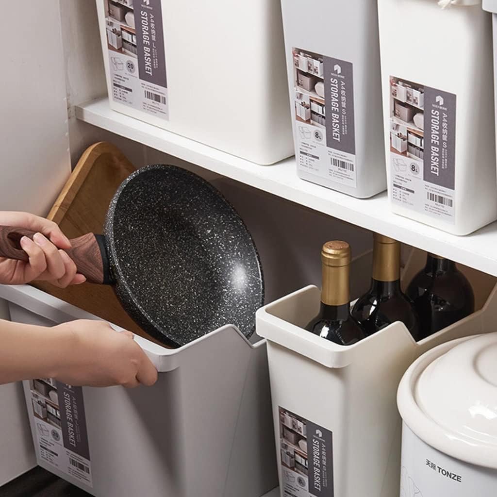 A person is placing a pan into the Large Capacity Cabinet Organizing Storage Box