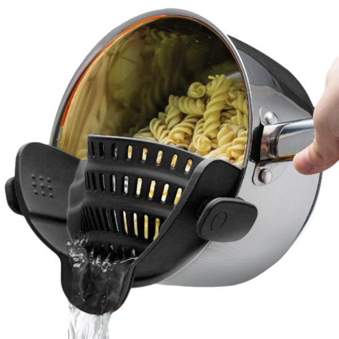 A Person is Straining Pasta By Attaching Adjustable Silicone Pot Pan Bowl Strainer.