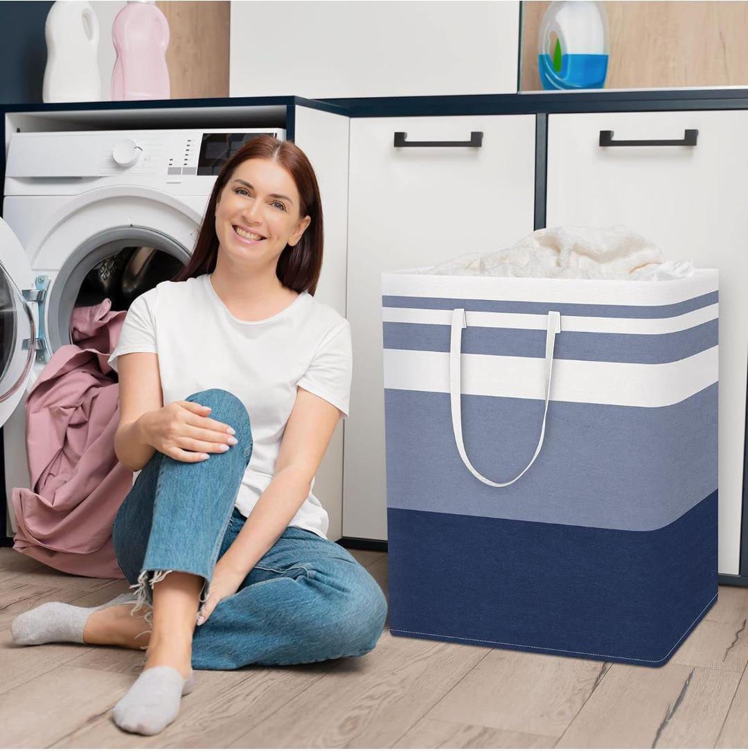 A Women Sitting Beside Foldable Cloth Storage Laundry Bin.