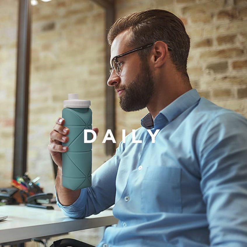A Person is Holding Foldable Silicone Travel Water Bottle.
