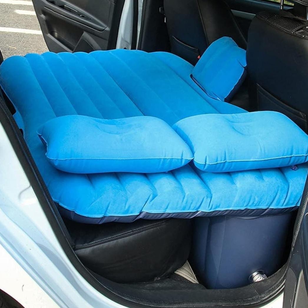 Blue color Inflatable Car Bed with pillow arranged in a car ready for use
