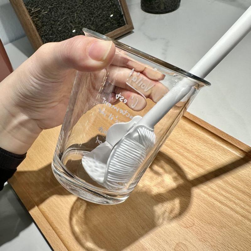 A Person is Cleaning Glass Cup Using  Bottle Cup Cleaning Brush with Long Handle.